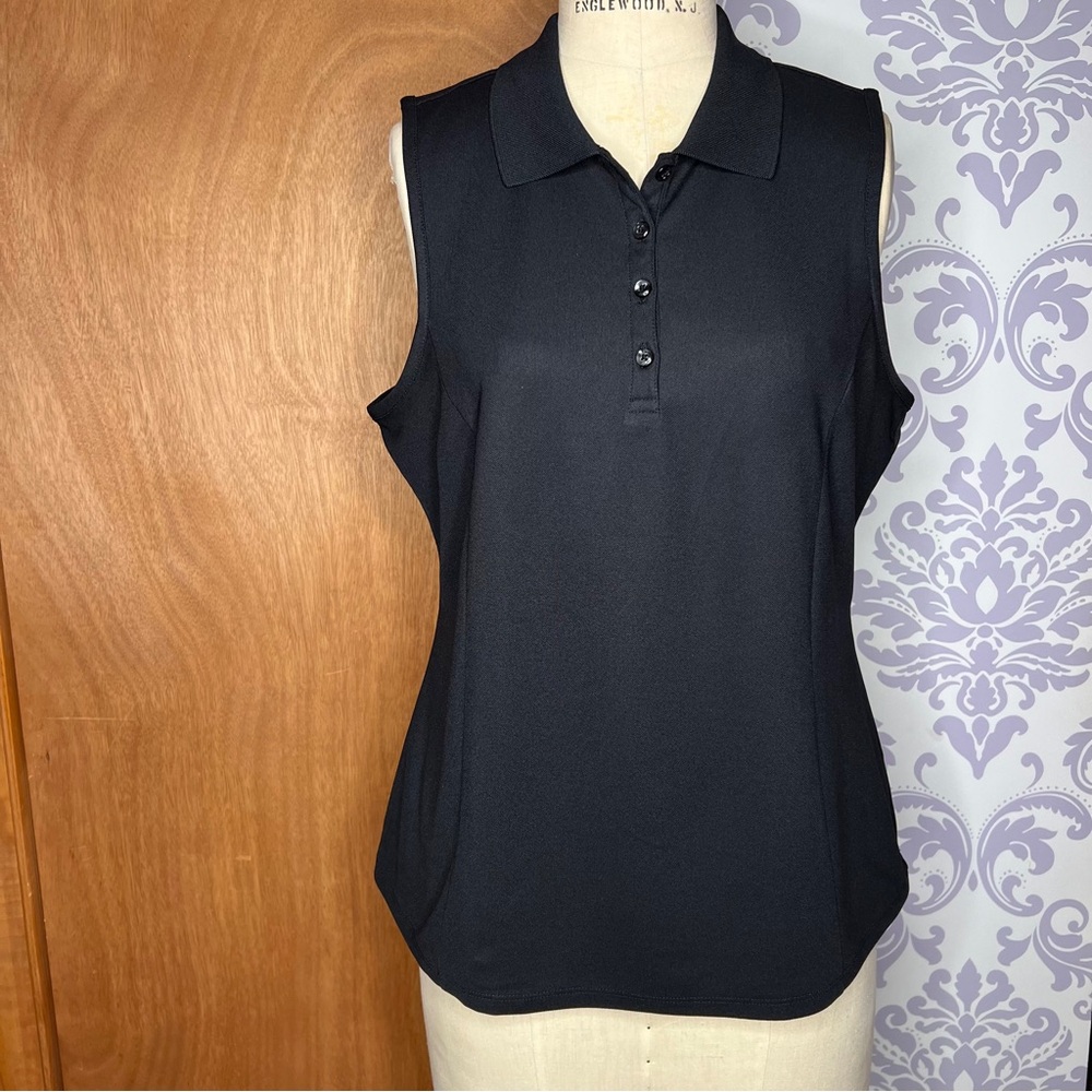 Greg Norman black sleeveless golf shirt.